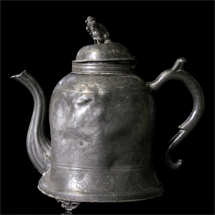 A Chinese pewter Swatow teapot, decorated with fish and figures with fo dog finial, 21cm high.