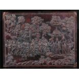 A Nepalese repousse copper plaque depicting a ceremonial procession, signed lower left, 33cm by