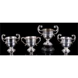 A group of four two-handled silver trophy cups, engraved, each 8cm high, (total weight 204g) (4).
