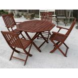 An octagonal folding garden table with four matching folding chairs.
