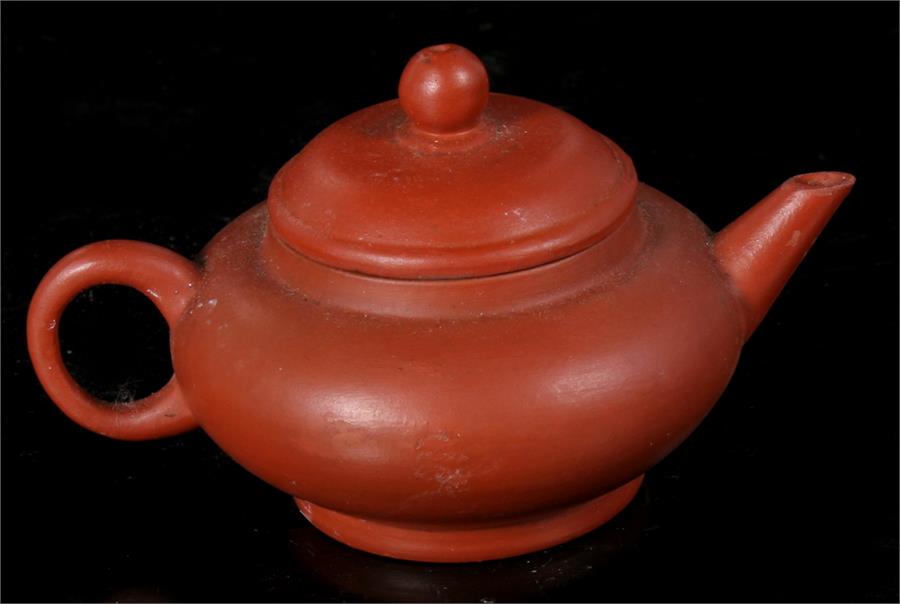 A Chinese Yixing pottery teapot with impressed mark to base, 5.5cm high.