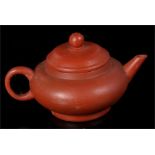 A Chinese Yixing pottery teapot with impressed mark to base, 5.5cm high.