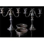 A pair of silver plated wine coasters, 16cm diameter, and a pair of silver plated three sconce