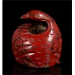 A Chinese lacquered hardwood carving in the form of a quail, 11cm high.