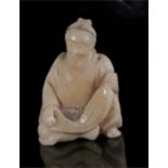 A 19th century Japanese ivory figure of a seated fisherman, 3.5cm high.