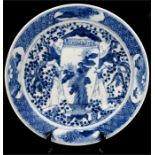 An early 19th century Chinese blue & white plate decorated with two figures and an oversized vase,