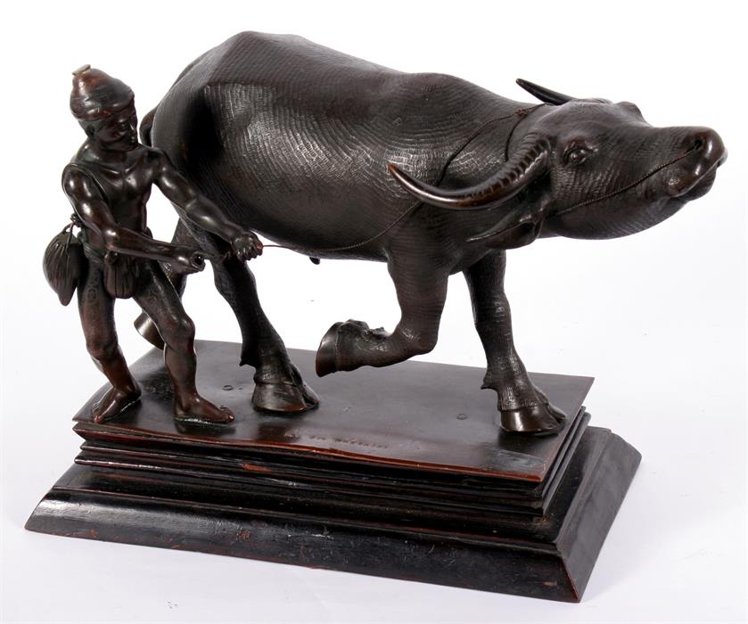 A Burmese Mandalay bronze group of an oxen and peasant, 27cm wide.