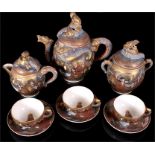 A late 19th century Japanese Satsuma pottery tea set, decorated in the 1000 Immortals pattern with