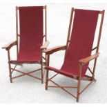 A pair of teak deckchairs.