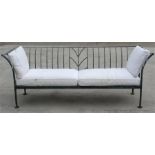 A very large galvanised garden bench with cream cushions, 291cm wide.