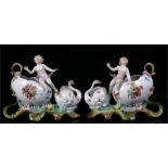 A pair of continential porcelain vases of egg shape form, mounted with swans and cherubs, 15cm wide.