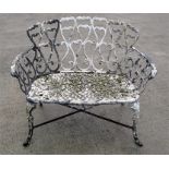 A white painted metal two-seater garden bench.