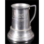 A Maritime Commemorative wagering tankard with three dice in the base, 16cm high.