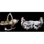 A Sitzendorf porcelain centrepiece, the floral encrusted basket supported by two cherubs, 23cm wide;