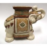 A modern ceramic garden seat or stand, in the form of an elephant.