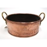 An oval copper & brass two-handled planter, 24cm x 18cm.