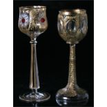 Two Bohemian gilt overlay long stemmed glasses, the largest 19cm high.