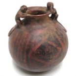 A South American pot with two monkey form handles 23cm high