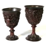 Two Regency Period carved treen goblets, one carved with a cherub and grape vines, 15.5cm high;