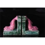 A pair of French Art Deco Lusca pottery fish vase book ends, the stylised pink scaled fish mounted