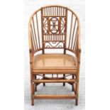 A hoop backed cane seated rattan conservatory chair.