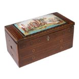 A 19th century mahogany sewing box with a Bilston enamel plaque inset to the top, decorated with