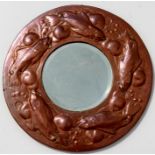 A Newlyn School style Arts and Crafts circular copper mirror in the manner of John Pearson,