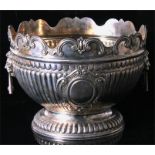 A large Edwardian silver monteith bowl, the reeded body below a rim cast with "C" scrolls applied
