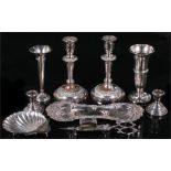 A pair of silver candlesticks, a silver trumpet vase, a silver vase, a silver shell dish, and a pair