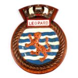 A hand painted aluminium ship's crest mounted on a wooden shield to the Frigate HMS Leopard, 25cm