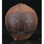 A coconut carving in the form of a head, possibly South Pacific, 12cm high.
