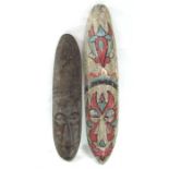 Two wooden tribal carved wall masks, 63cm and 51cm high (2).