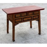 A late 19th century Chinese elm alter table, the red painted top above two short drawers, on