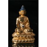 A gilded bronze Buddha, seated in meditation, 8cm high.