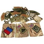 A quantity of British Army embroidered cloth badges including army commando and division insignia.