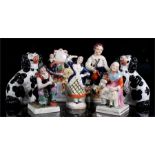 A group of 19th century Staffordshire figures including a pair of spaniels, the cobbler and his