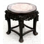 A Chinese hardwood occasional table with figured pink marble inset top and pierced and carved