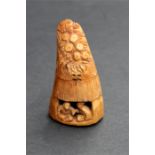 A Japanese tooth carving depicting two figures sat in a hut, with two character mark to the base,