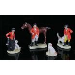 A group of four early 20th century painted bisque cake decorations of huntsman and hounds, each