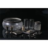 A pair of silver topped dressing table jars, a silver cigarette case, a silver photo frame, and