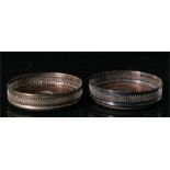 A pair of silver plated and mahogany coasters, 13cm diameter.