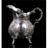 A Continential silver jug with foliate scroll decoration, 7cm high, weight 109g.