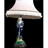 A Japanese porcelain figural table lamp depicting a young woman wearing a blue robe and holding a