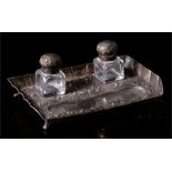 A Victorian two-bottle silver inkstand, decorated in relief with foliate scrolls, London 1891,