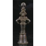 An Indian bronze figural bell, 23cm high.