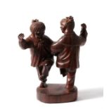 A mid 20th century Chinese Republic figural hardwood carving depicting two girls dancing, 15cm (