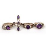 Four amethyst set silver dress rings.