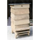 A four tier painted wooden beehive, 65cms wide.