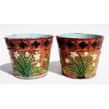 A pair of 19th century majolica planters decorated in relief with flowers, impressed marks to