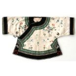 A Chinese silk short robe embroidered with flowers and butterflies on a cream ground, with